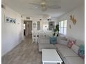 Bright living room with a cozy sectional sofa, an airy ceiling fan, and light-colored wood-look tile flooring at 4505 45Th W Ave # 101B, Bradenton, FL 34210