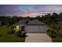 Beautiful exterior view of the home during dusk, featuring lush landscaping and a well-maintained lawn at 4515 Roycroft Ter, Parrish, FL 34219