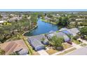 Beautiful aerial view of a home on the water with a lush green landscape and blue lake at 4604 9Th E Ave, Bradenton, FL 34208