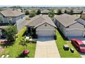 An aerial view of a single-Gathering home that showcases a well-maintained front yard and a private driveway at 4722 Lindever Ln, Palmetto, FL 34221