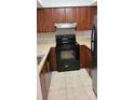 The Kitchen has stainless steel appliances, tiled floors, and dark cabinets at 4941 25Th W St # 101, Bradenton, FL 34207
