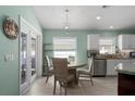 Bright dining area with a round table, chairs, and a view to the backyard through sliding glass doors at 5209 Lansdowne Way, Palmetto, FL 34221