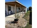 Exterior view of the home featuring a covered patio and well-maintained landscaping at 6357 Partridge Ave, Englewood, FL 34224