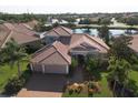 Stunning aerial view of the home showcasing its prime location near a lake and lush landscaping at 6951 Scrub Jay Dr, Sarasota, FL 34241