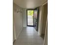 Inviting entryway with tile flooring and bright natural light streaming through the open front door at 7050 Fairway Bend Ln # 167, Sarasota, FL 34243