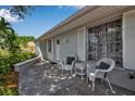 Inviting front porch with seating, white shutters, and well-maintained landscaping at 709 84Th Nw St, Bradenton, FL 34209