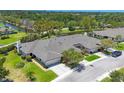 Aerial view of a home surrounded by lush landscaping, with a nearby waterway at 7374 Royal Birkdale Dr # 15D, Sarasota, FL 34238