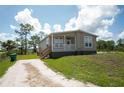 Exterior of home features landscaping, gravel driveway, and inviting porch at 8226 Sweden Blvd, Punta Gorda, FL 33982