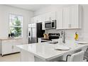 Bright kitchen featuring quartz countertops and stainless steel appliances at 8545 Daybreak St, Sarasota, FL 34241