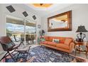 Cozy living room with a stylish rug, comfortable seating, and sliding glass doors leading to the pool area at 9012 Province St, Sarasota, FL 34240