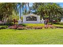 A beautifully landscaped entrance sign for the River Club, a deed-restricted community at 9915 Old Hyde Park Pl, Bradenton, FL 34202