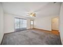 Bright living room with carpet, ceiling fan, and large window offering natural light at 1007 Southern Pine Ln, Sarasota, FL 34243