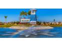 Community entrance featuring a water fountain and the Bella Lago sign surrounded by lush landscaping at 10708 Tippecanoe Pl, Parrish, FL 34219