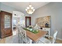 Dining room featuring an elegant chandelier, wood table with seating for six, and decorative display cabinets at 11 Lateen Sail Dr, Placida, FL 33946