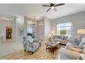 Airy living room features a ceiling fan, comfortable seating, and a view of the entryway at 11 Lateen Sail Dr, Placida, FL 33946