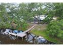 Stunning backyard view featuring a private dock, serene water, and lush green trees at 1130 Mill Creek Rd, Bradenton, FL 34212