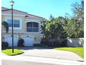 Well-maintained Mediterranean-style townhome with brick-paved driveway, garage and mature landscaping at 116 Navigation Cir # 106, Osprey, FL 34229