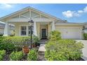 Inviting single-Gathering home with a lovely front porch, lush greenery, and a well-maintained lawn at 12133 Forest Park Cir, Bradenton, FL 34211