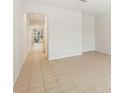 Bright living room with tile flooring and archway to other parts of the home at 12358 Destiny Dr, Venice, FL 34292