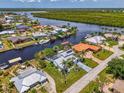 Scenic aerial view of waterfront homes with canals, docks, and boats in a picturesque coastal neighborhood at 127 Colonial Sw St, Port Charlotte, FL 33952