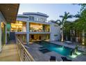 Luxury outdoor living featuring a large pool, lounge chairs, and landscaped backyard at 1365 Harbor Dr, Sarasota, FL 34239