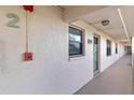 Exterior hallway with unit number, stucco siding and outdoor lighting at 175 Kings Hwy # B5, Punta Gorda, FL 33983