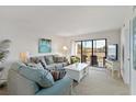 Comfortable living room with large sofa, coffee table, and balcony access at 175 Kings Hwy # B5, Punta Gorda, FL 33983
