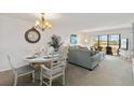 Bright living room with dining area and sliding doors leading to the balcony at 175 Kings Hwy # B5, Punta Gorda, FL 33983