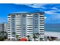 Exterior of a modern condo building with a blue rooftop overlooking the ocean at 1750 Benjamin Franklin Dr # 6F, Sarasota, FL 34236