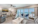 Inviting living room with ocean views, comfortable seating, and access to the balcony at 1800 Gulf N Dr # 112, Bradenton Beach, FL 34217