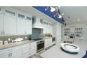 Bright kitchen showcasing white cabinetry, stainless steel appliances, and a large countertop for ample space at 212 Spring Ave, Anna Maria, FL 34216