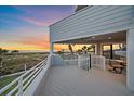 Relaxing balcony with stunning ocean views, perfect for enjoying sunsets and outdoor dining with comfortable seating at 216 Tenacity Ln, Sarasota, FL 34242