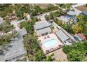 Aerial view of the home with a private backyard pool and lush landscaping at 2165 Lemon Ave, Englewood, FL 34223