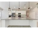 Bright kitchen with granite counters, stainless steel appliances, and modern pendant lighting at 2303 58Th E St, Palmetto, FL 34221