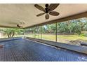 Spacious screened lanai with tiled flooring, ceiling fans, and a view of the backyard at 2303 58Th E St, Palmetto, FL 34221