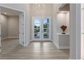 Inviting foyer with modern lighting, stylish flooring, and elegant decor leading into a home's living spaces at 2319 Webber St, Sarasota, FL 34239