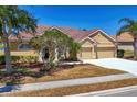 Charming one-story home with a red tile roof, well-manicured landscaping, and a two-car garage at 246 Petrel Trl, Bradenton, FL 34212