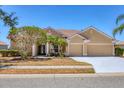 Charming one-story home with a red tile roof, well-manicured landscaping, and a two-car garage at 246 Petrel Trl, Bradenton, FL 34212
