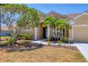 Inviting front entrance with landscaped garden and manicured lawn of a charming home at 246 Petrel Trl, Bradenton, FL 34212
