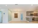 Open living space featuring tile floors, recessed lighting, and a seamless transition to the kitchen at 301 89Th Ne Ave, St Petersburg, FL 33702