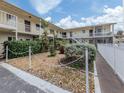 Manicured condo courtyard with fence and walkway showing well maintained community at 340 Base E Ave # 314, Venice, FL 34285