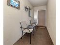 Private front porch has tile floor and chairs for relaxing outdoors at 340 Base E Ave # 314, Venice, FL 34285