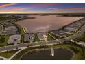 Panoramic aerial view of the neighborhood and beautiful lake at sunset at 508 Blue Shell Loop, Sarasota, FL 34240
