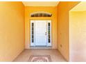 Welcoming front entrance featuring a white door with sidelights and decorative tiled floor at 5168 Cillette Ave, North Port, FL 34288