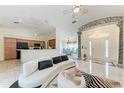 Open-concept living area with elegant marble floors, stylish seating, and access to the kitchen at 5168 Cillette Ave, North Port, FL 34288