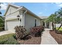 Beautiful home exterior featuring manicured landscaping, a well-lit walkway, and a two-car garage on a sunny day at 5238 Aqua Breeze Dr, Bradenton, FL 34208