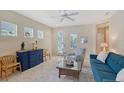 Inviting living room with neutral walls, tile floors, stylish furniture, and natural light streaming through the windows at 5238 Aqua Breeze Dr, Bradenton, FL 34208