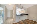 Open-concept living space with hardwood floors and an open view to the bright kitchen at 5269 Wedgewood Ln # 36, Sarasota, FL 34235
