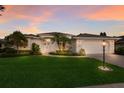 Charming single-story home with a manicured lawn, mature trees and a side entry two-car garage at 5782 Sandy Pointe Dr, Sarasota, FL 34233