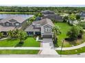 Gorgeous home with an expansive yard, complemented by a serene lake and lush greenery in a desirable community at 5978 Anise Dr, Sarasota, FL 34238